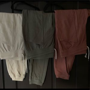 Three pairs of joggers (burnt pink, green, cream)